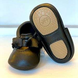 Freshly picked black leather moccasins.